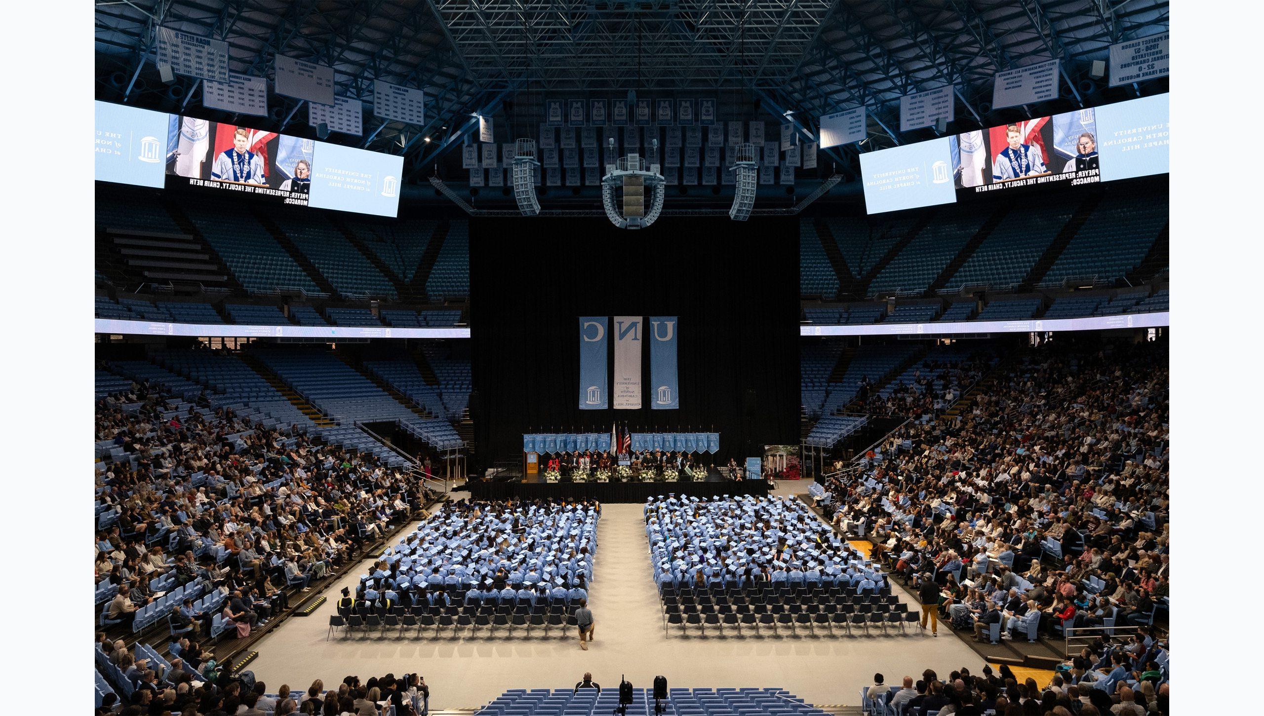 Long-range shot of the crowd and audience at U.N.C. Hill's Winter Commencement at the Dean E. Smith Center